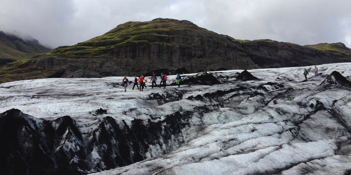The Green Program case study: image of students in brightly-colored jackets on a glacier beneath a bright but cloudy sky