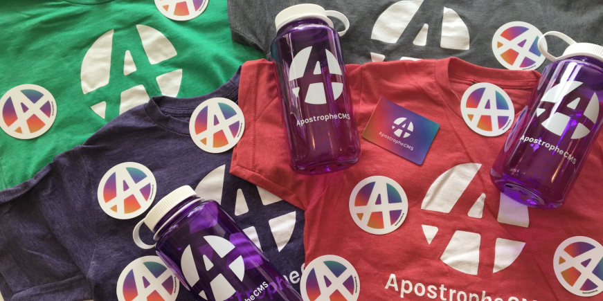 Photo of ApostropheCMS swag -- t-shirts, stickers, and nalgene bottles - for NodeJS Interactive 2017